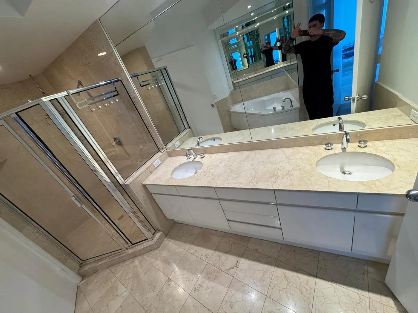 Finished master bathroom with double vanity and glass shower