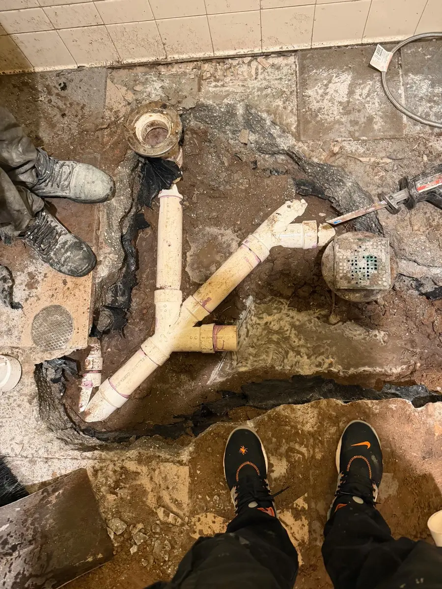 Broken drain line exposed and replaced under a concrete floor